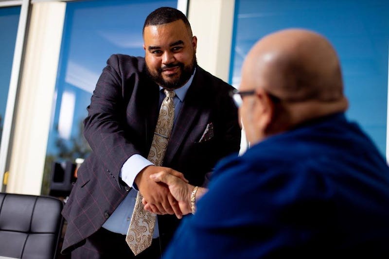 Vincent Hughes shaking hands with a man