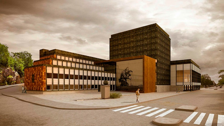 henkilö seisoo rakennuksen edessä