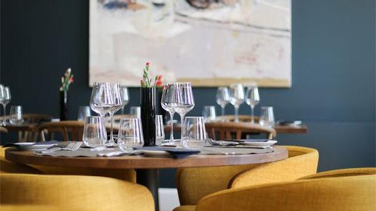 ruokasali, jossa on keltaiset tuolit ja maalaus seinällä