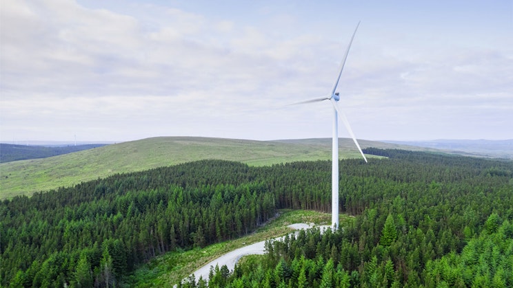 Ilmakuva tuuliturbiinista keskellä metsää.