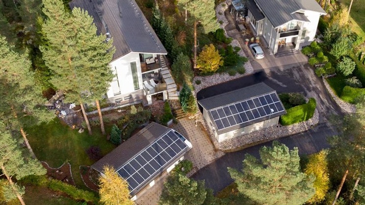 an aerial view of a house with solar panels on the roof