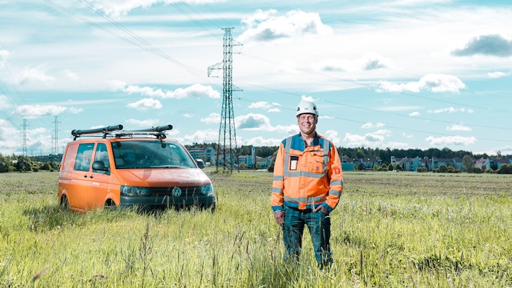 a man standing next to a van in a field