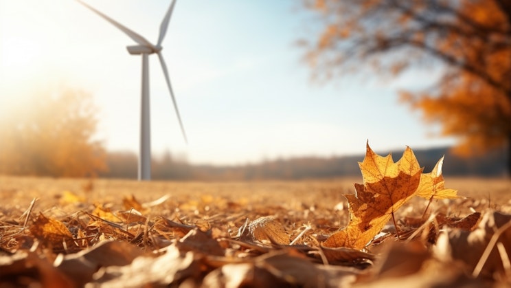 lehti makaa maassa tuuliturbiinin edessä