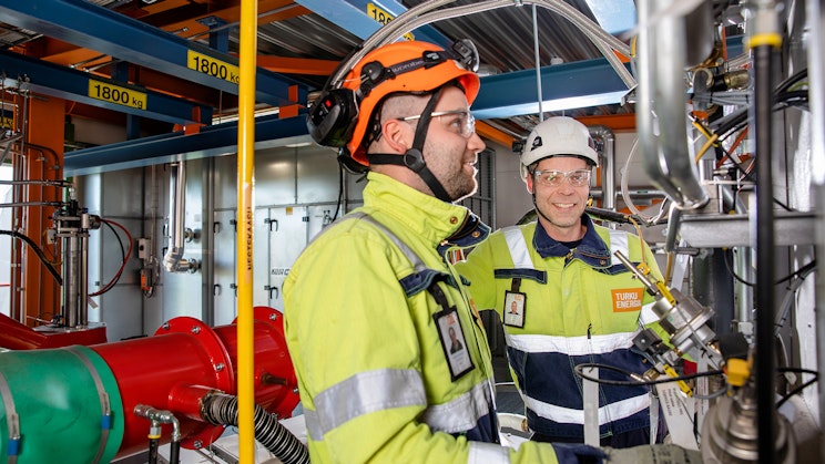 Kuvassa kaksi miestä työasuissa