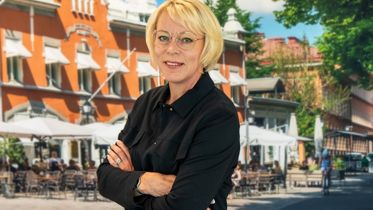 Kuvassa nainen poseeraa aurinkoisen taustan edessä