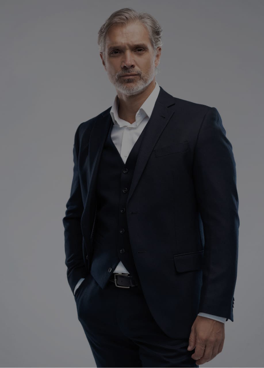 Handsome man with salt and pepper hair wearing a suit