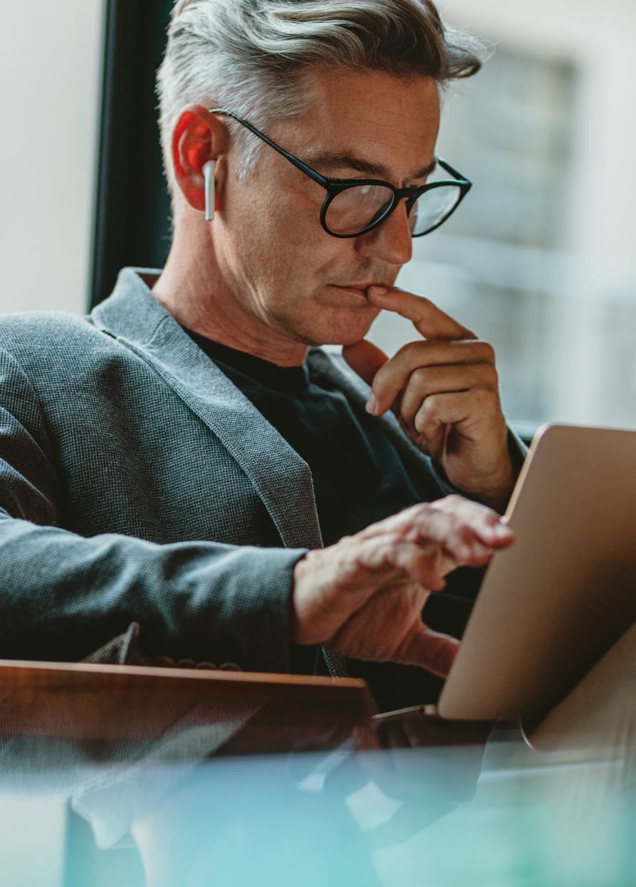 Man sitting down looking at a computer