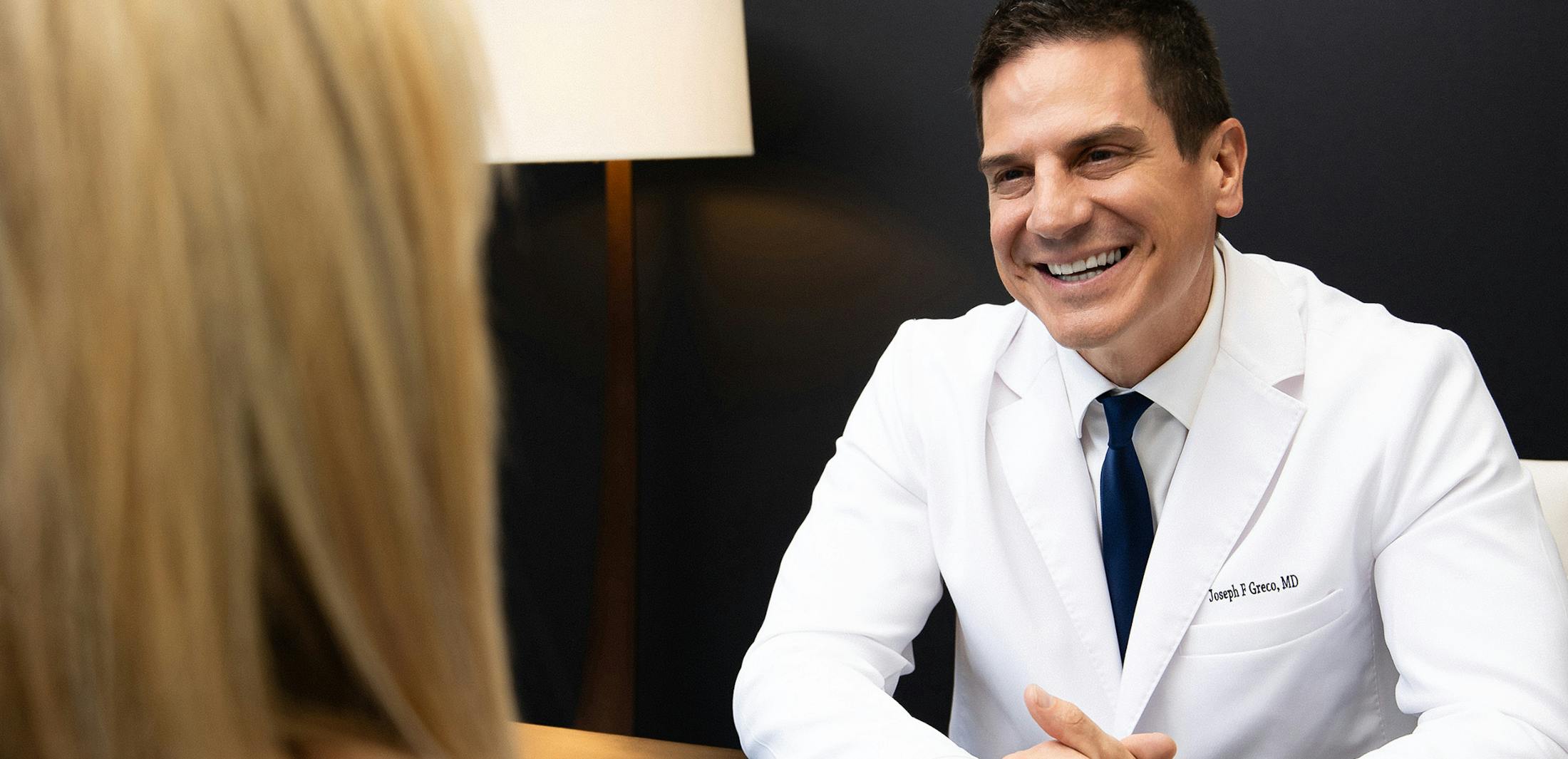 Dr. Greco III smiling at a patient