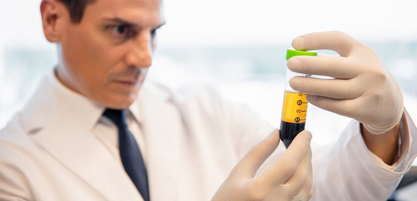 Dr. looking at a vile