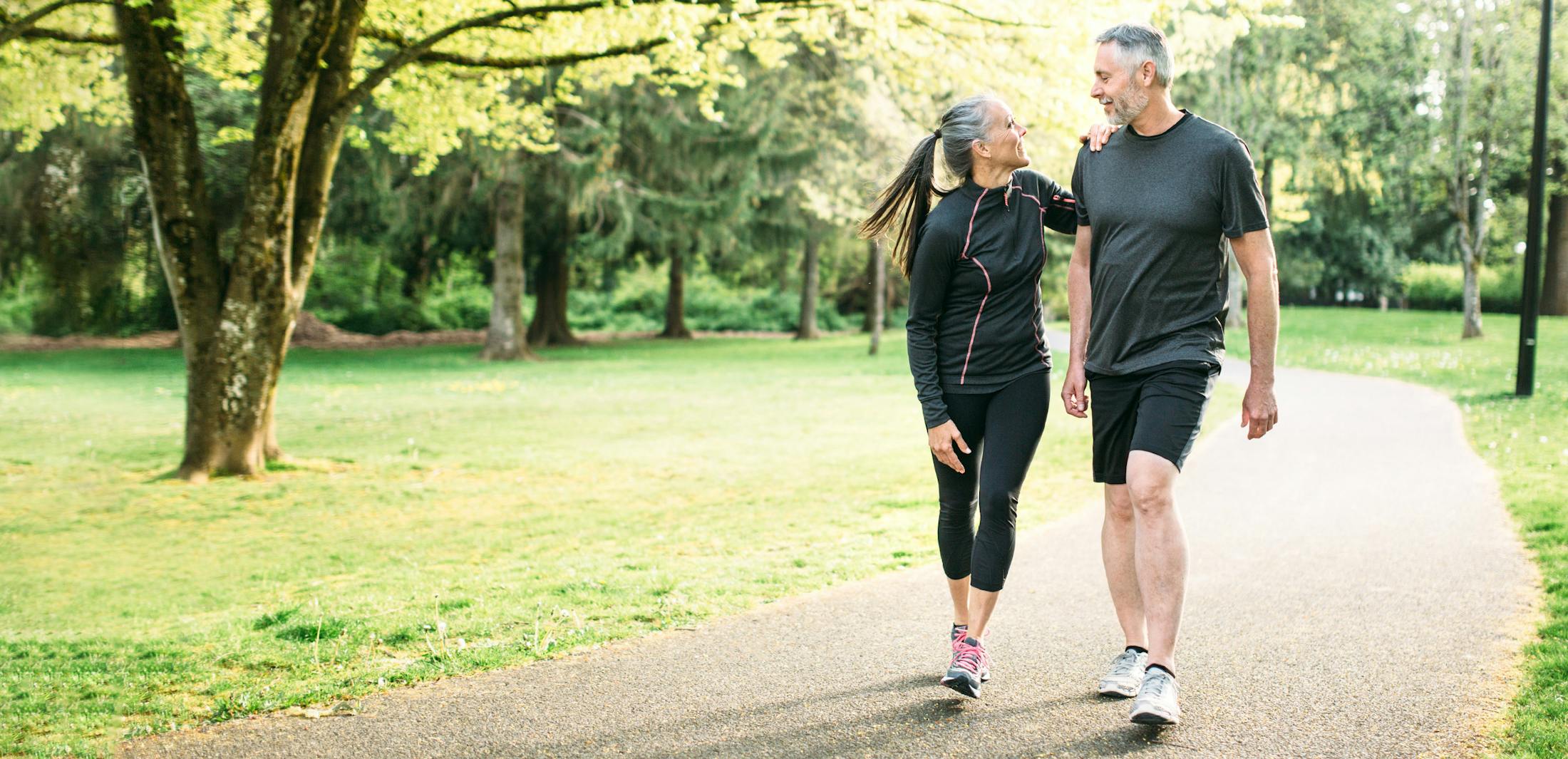 man and woman walking on a trail
