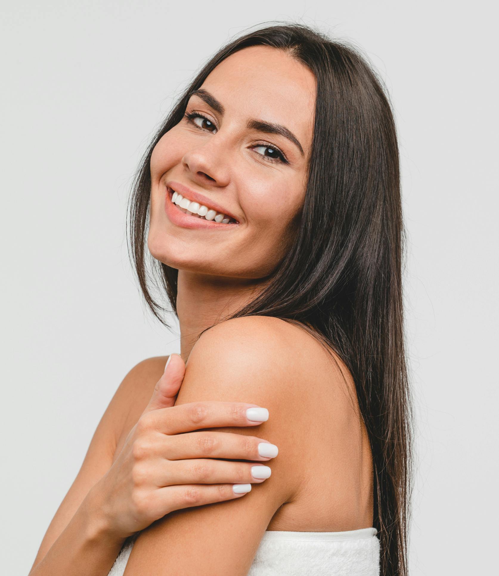 Woman with long brown hair smiling