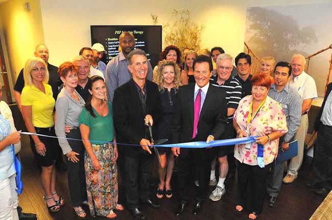 picture of a group and a ribbon cutting