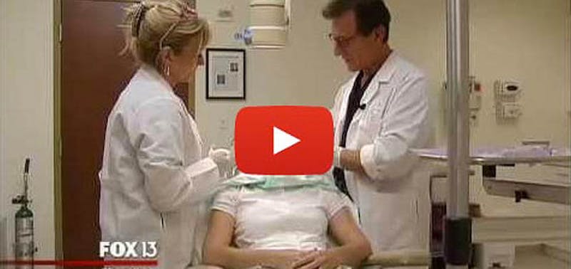 picture of Dr. Greco and a play button