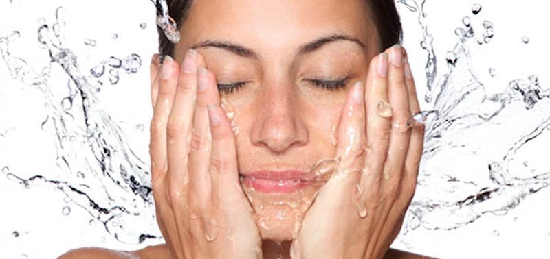 woman washing her face