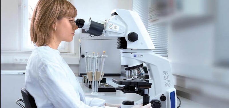 woman looking for microscope