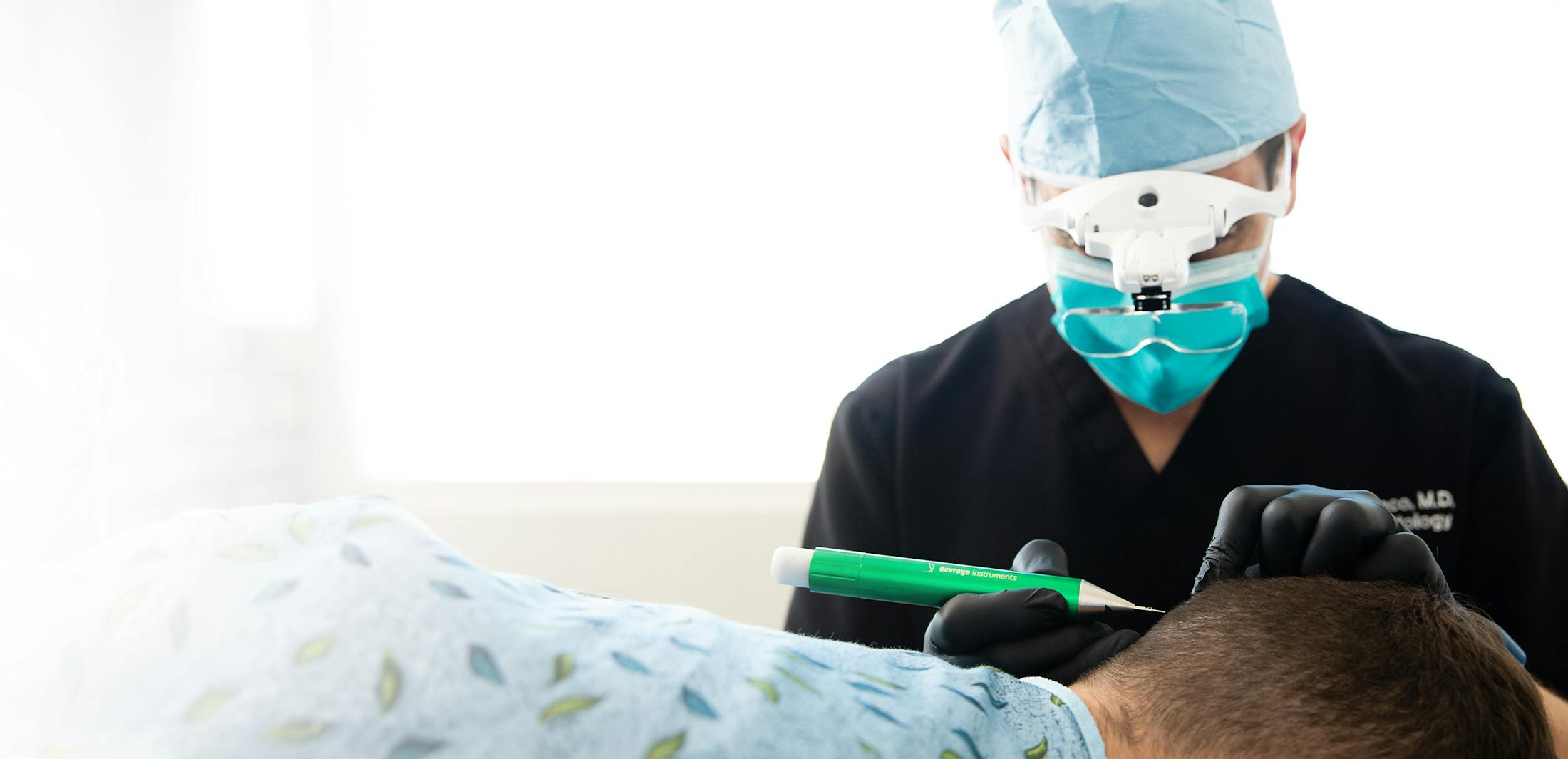 Dr. performing a surgical hair procedure