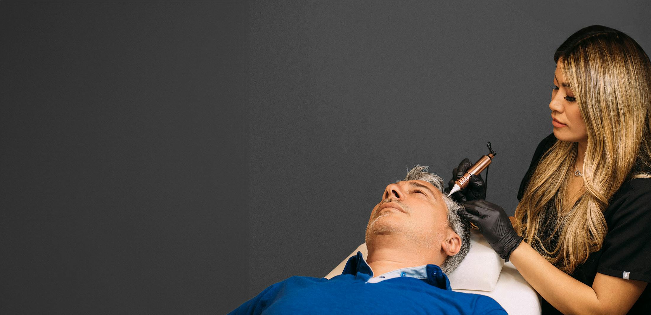 Male patient receiving scalp micropigmentation treatment at Greco Hair Restoration in the Tampa & Sarasota FL areas