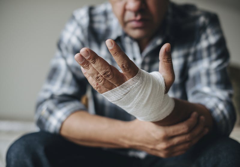 Man with bandage on his hand