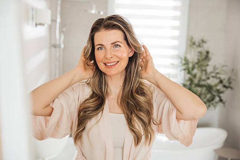 Woman Looking at Her Reflection in the Mirror