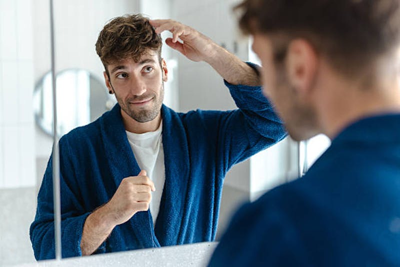 Man Looking at His Reflection