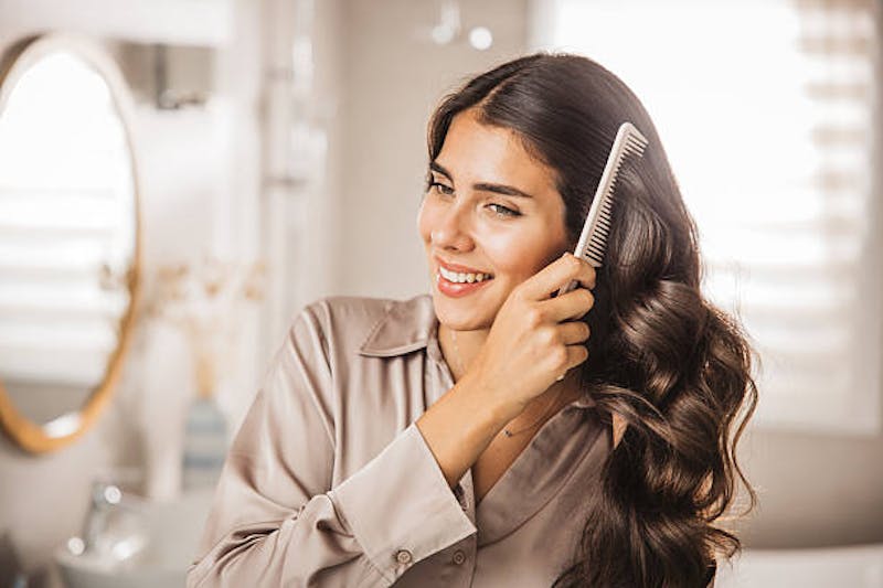 Woman with combing her hair