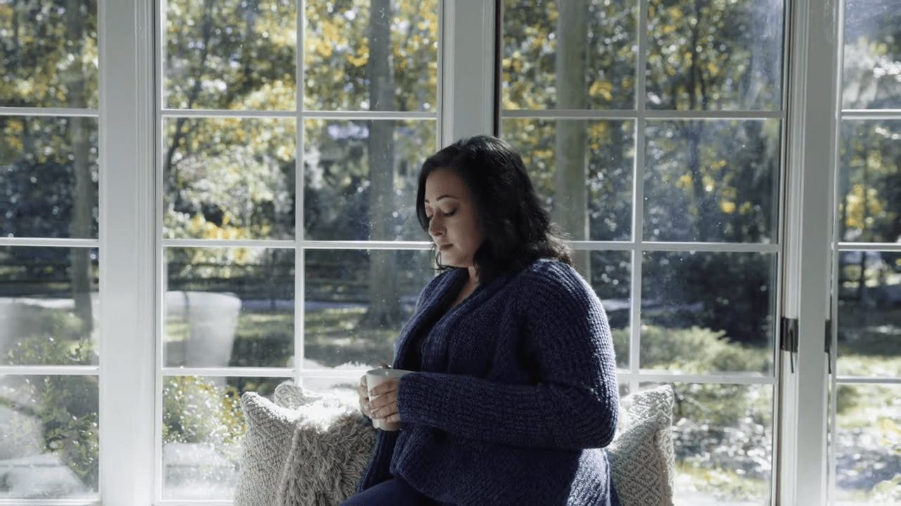 Woman sitting with cup of coffee