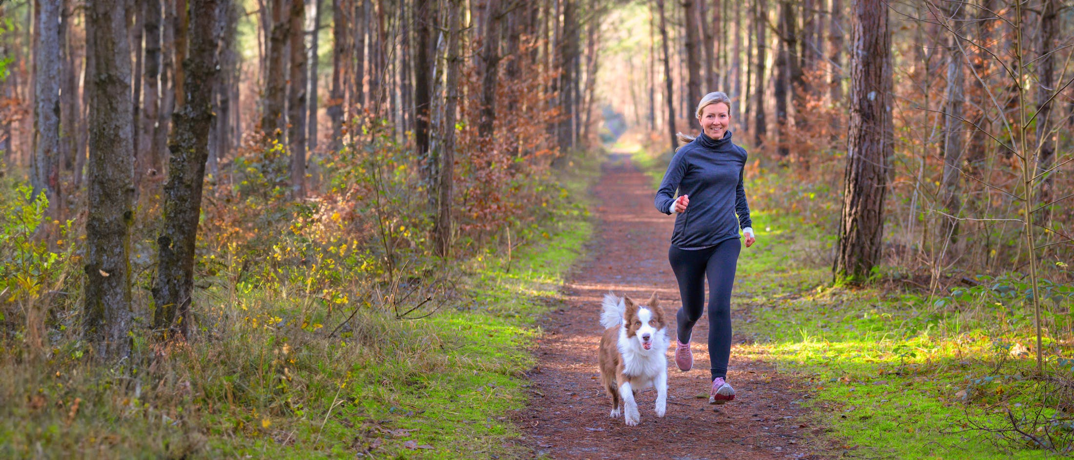 Woman running with dog