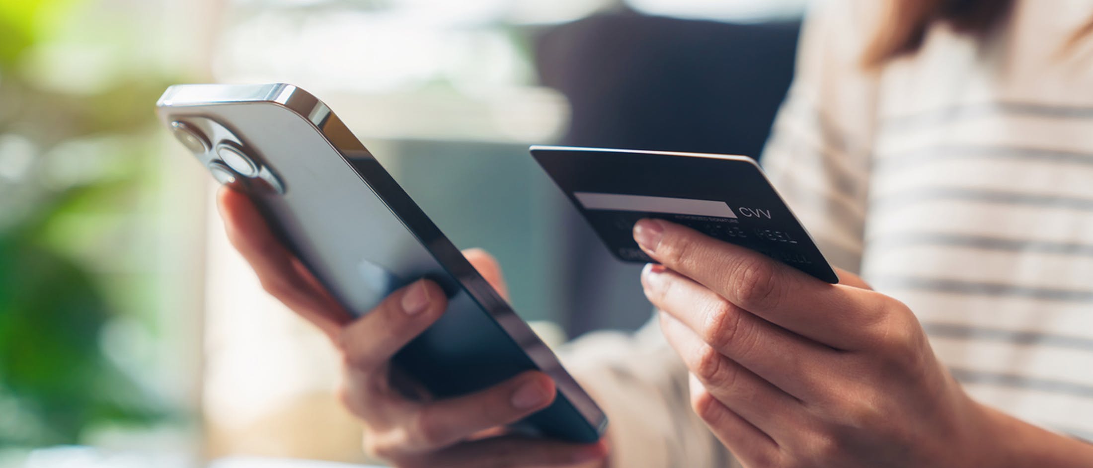 Person holding phone and credit card