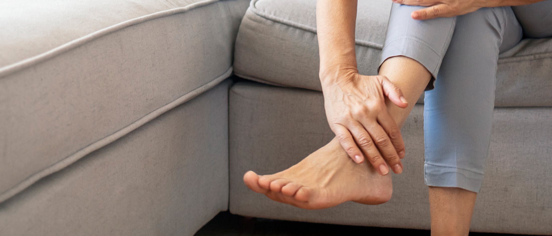 Person holding their foot
