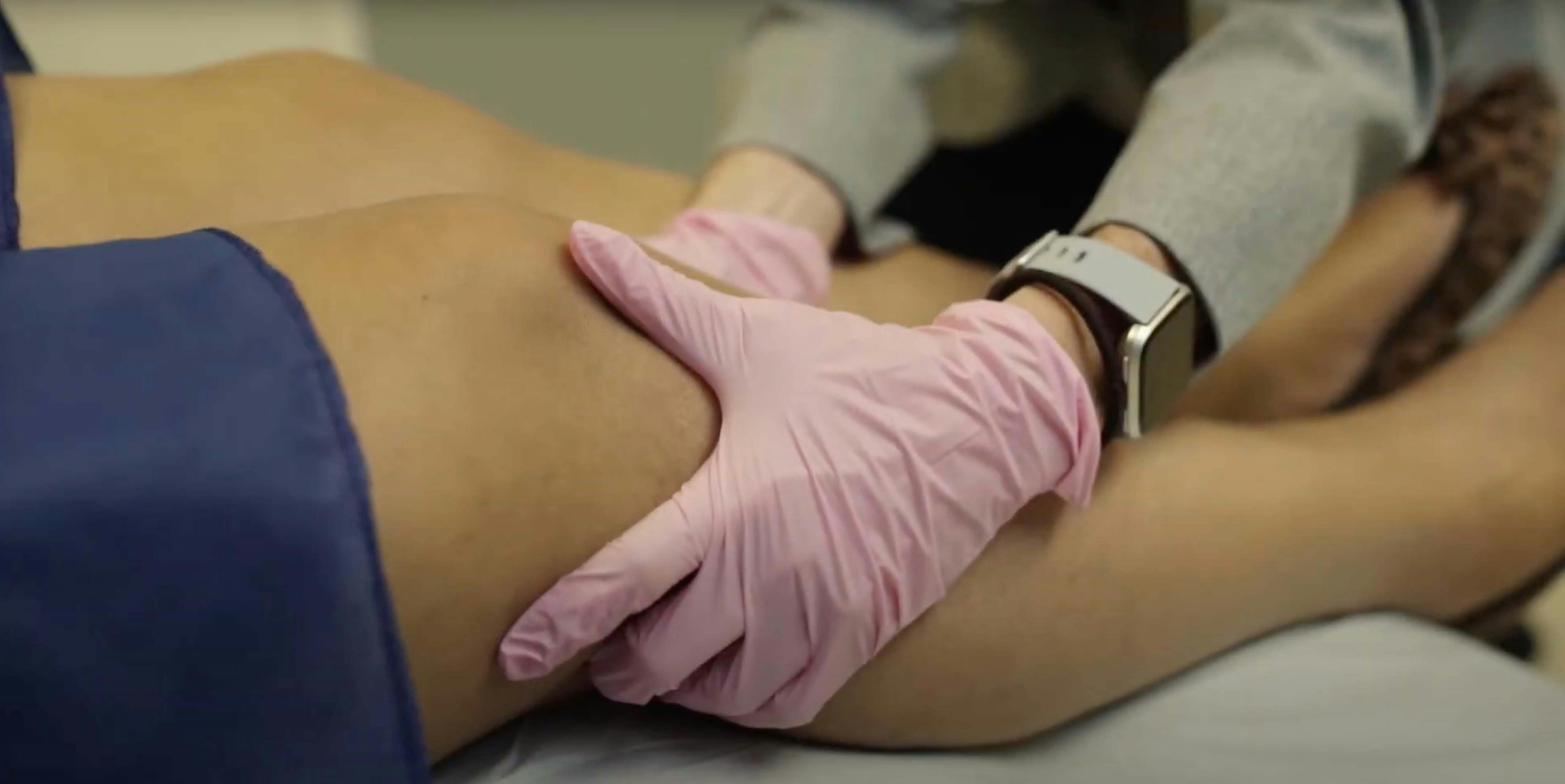 Doctor examining leg