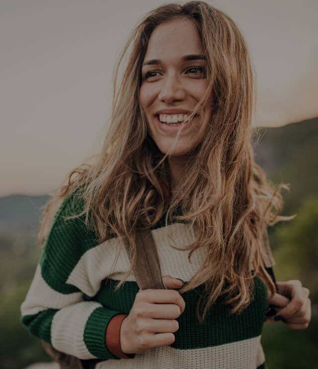 Happy woman outdoors hiking.