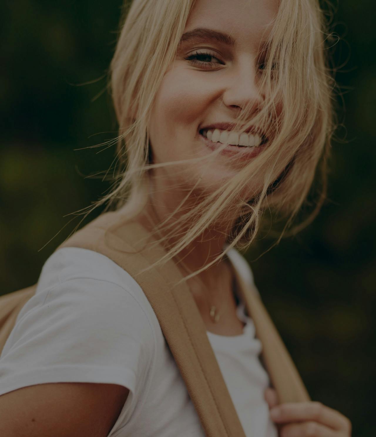 Smiling hiking woman outside.