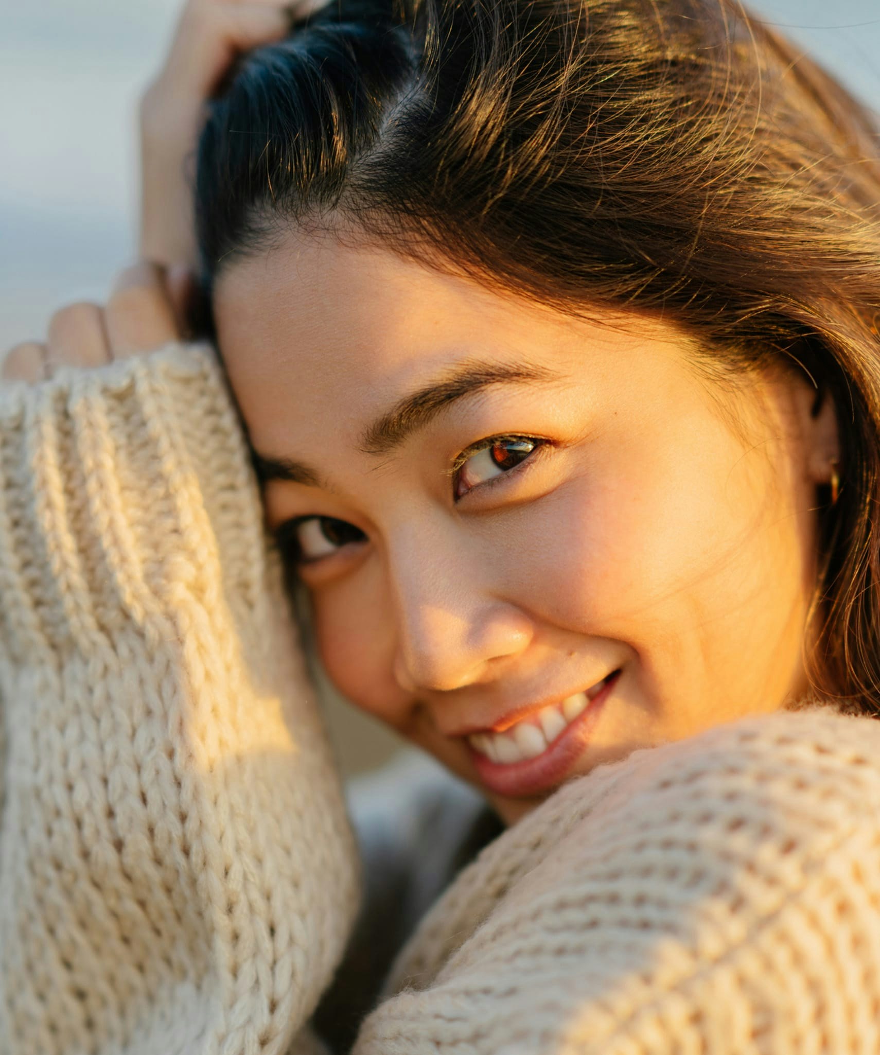 Woman in knitted sweater smiling