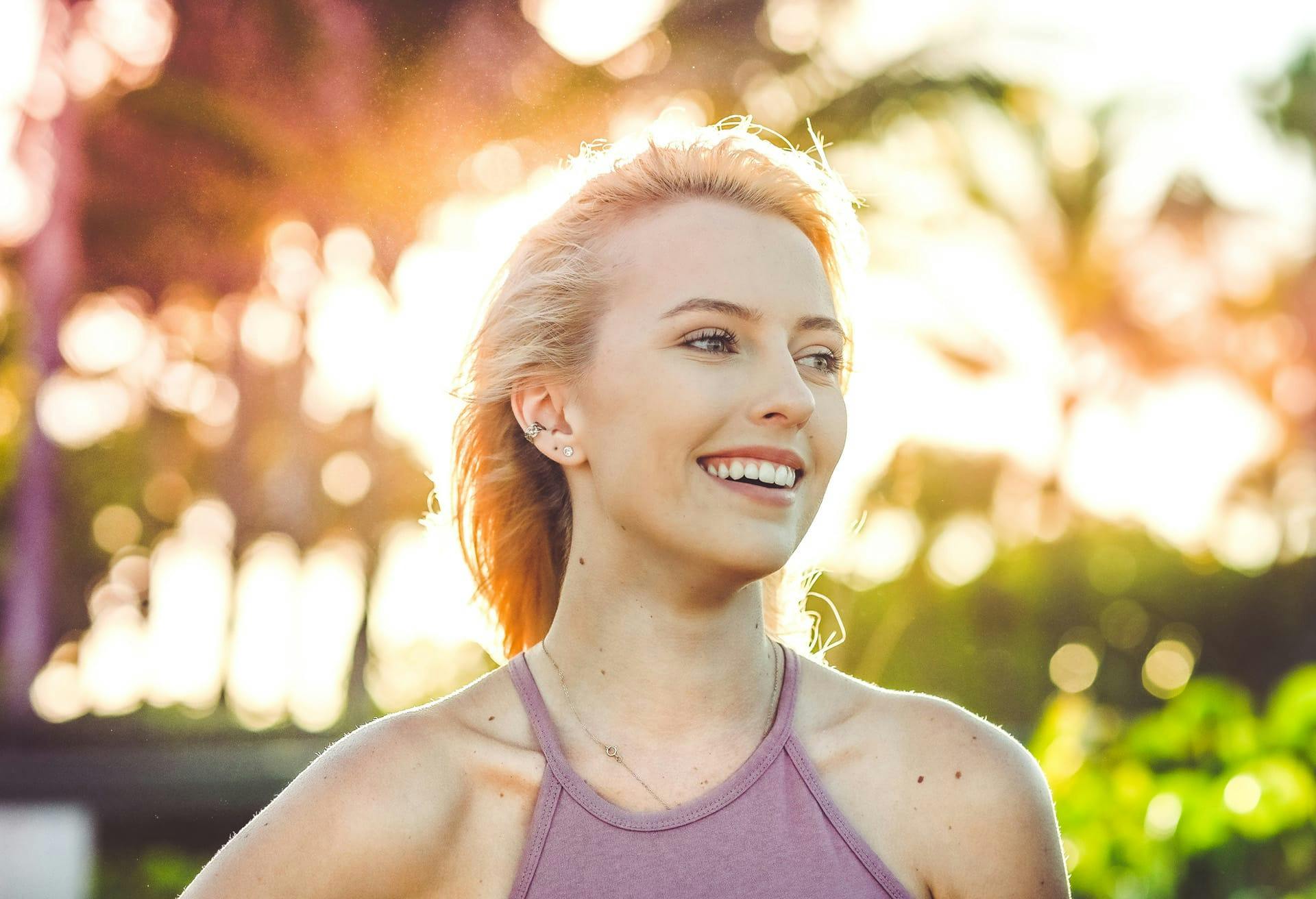 Woman in pink halter top smiling