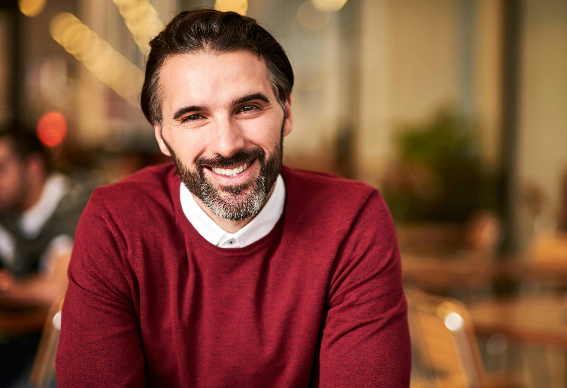 Bearded man smiling.