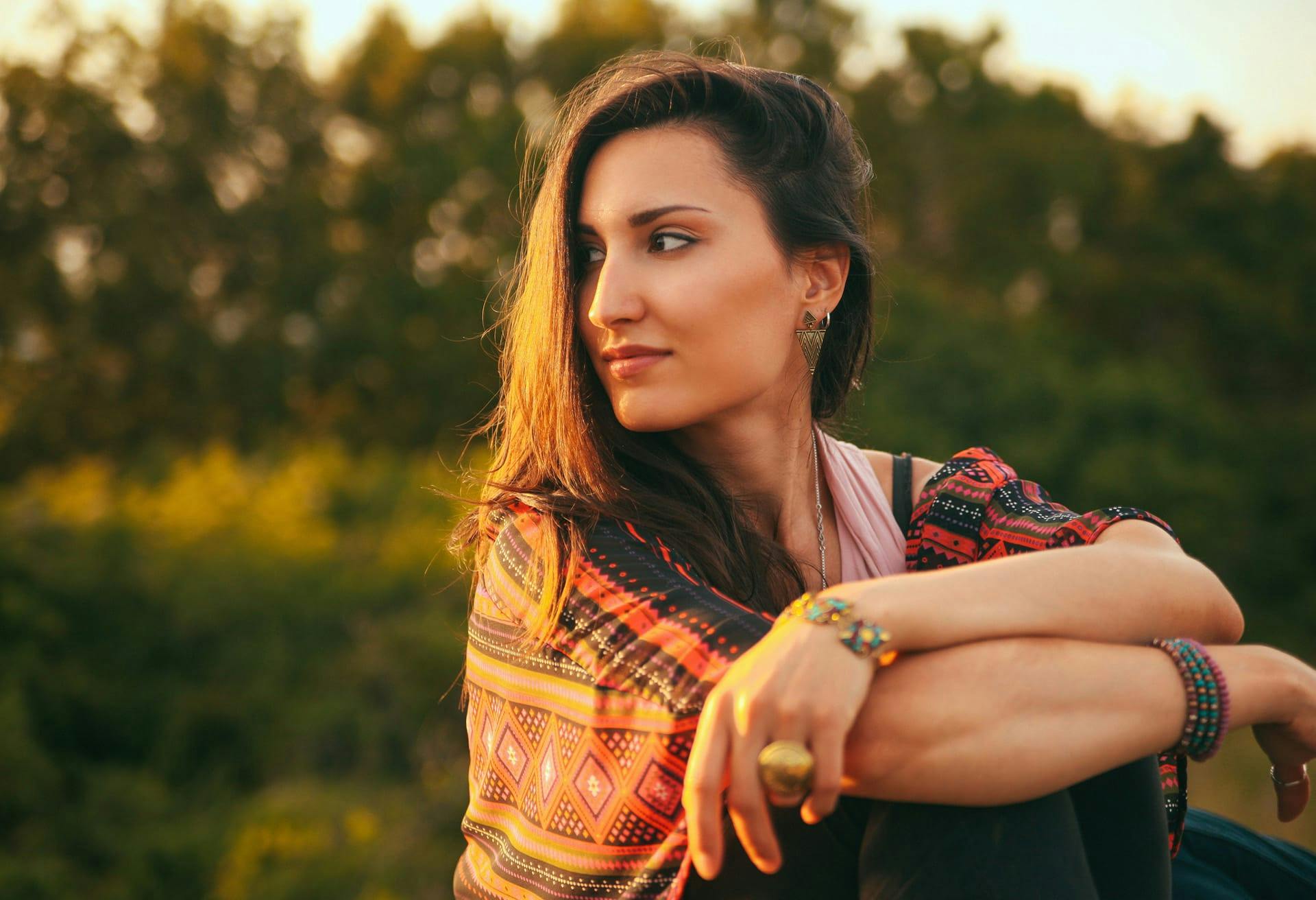 Woman in patterned shawl looking over shoulder.