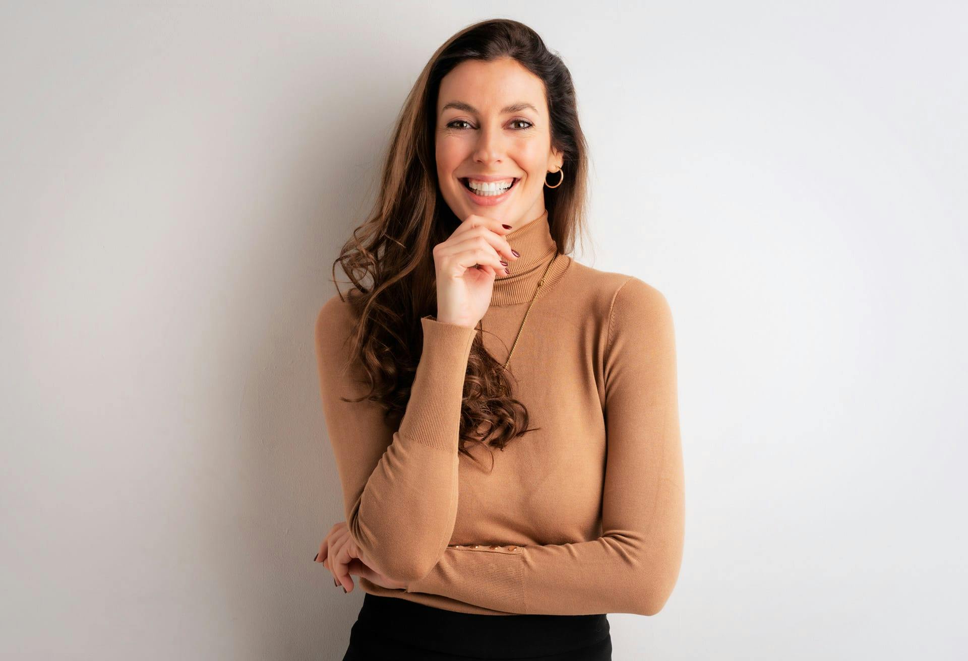 Woman in light brown turtle neck