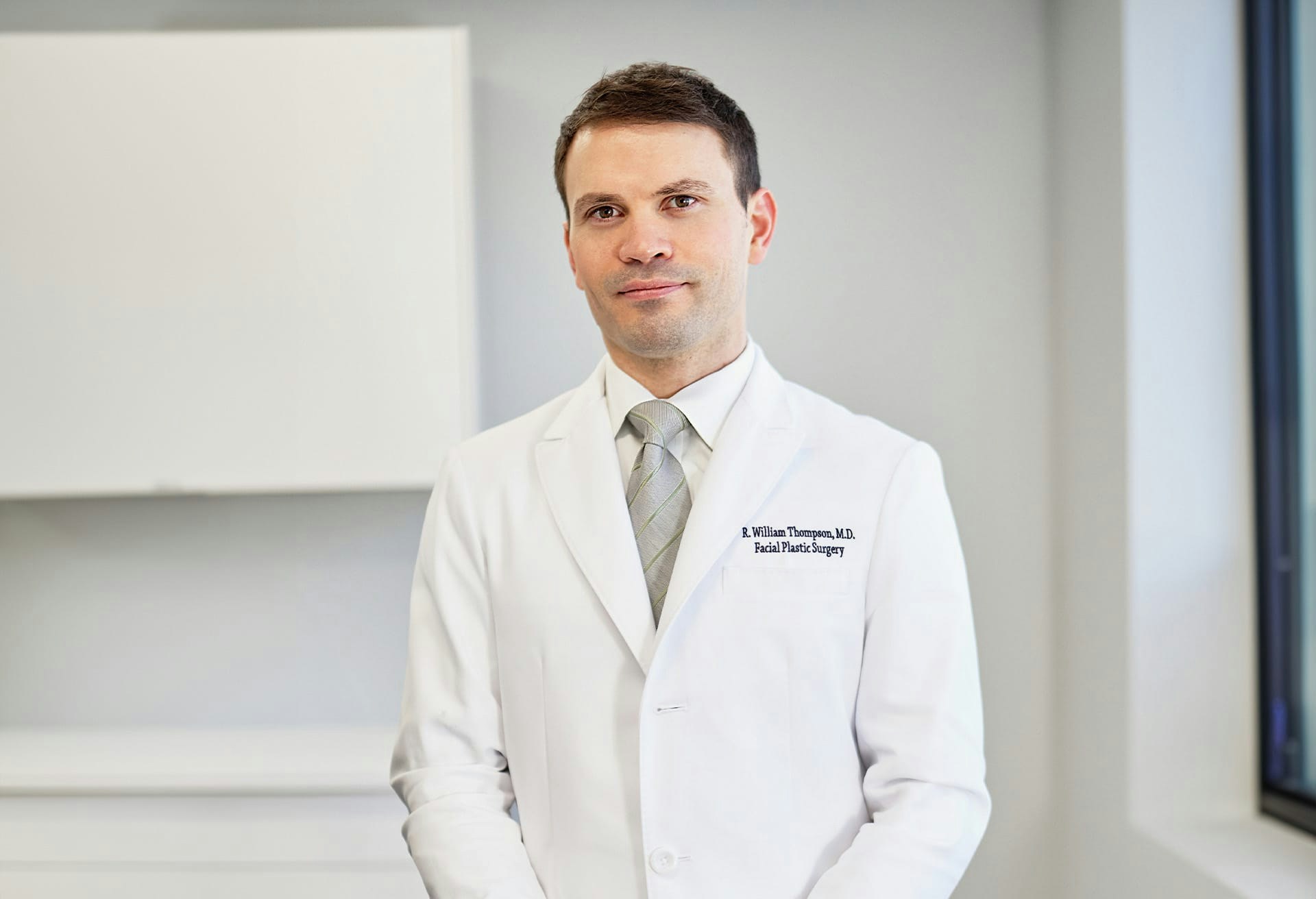 Doctor Thompson wearing doctor's coat.