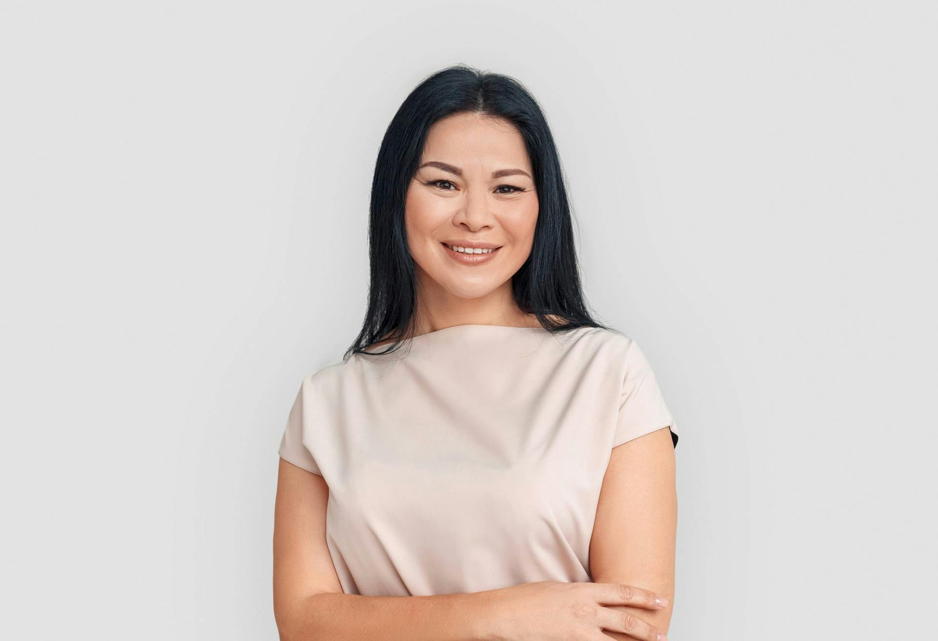 Woman in nude top smiling