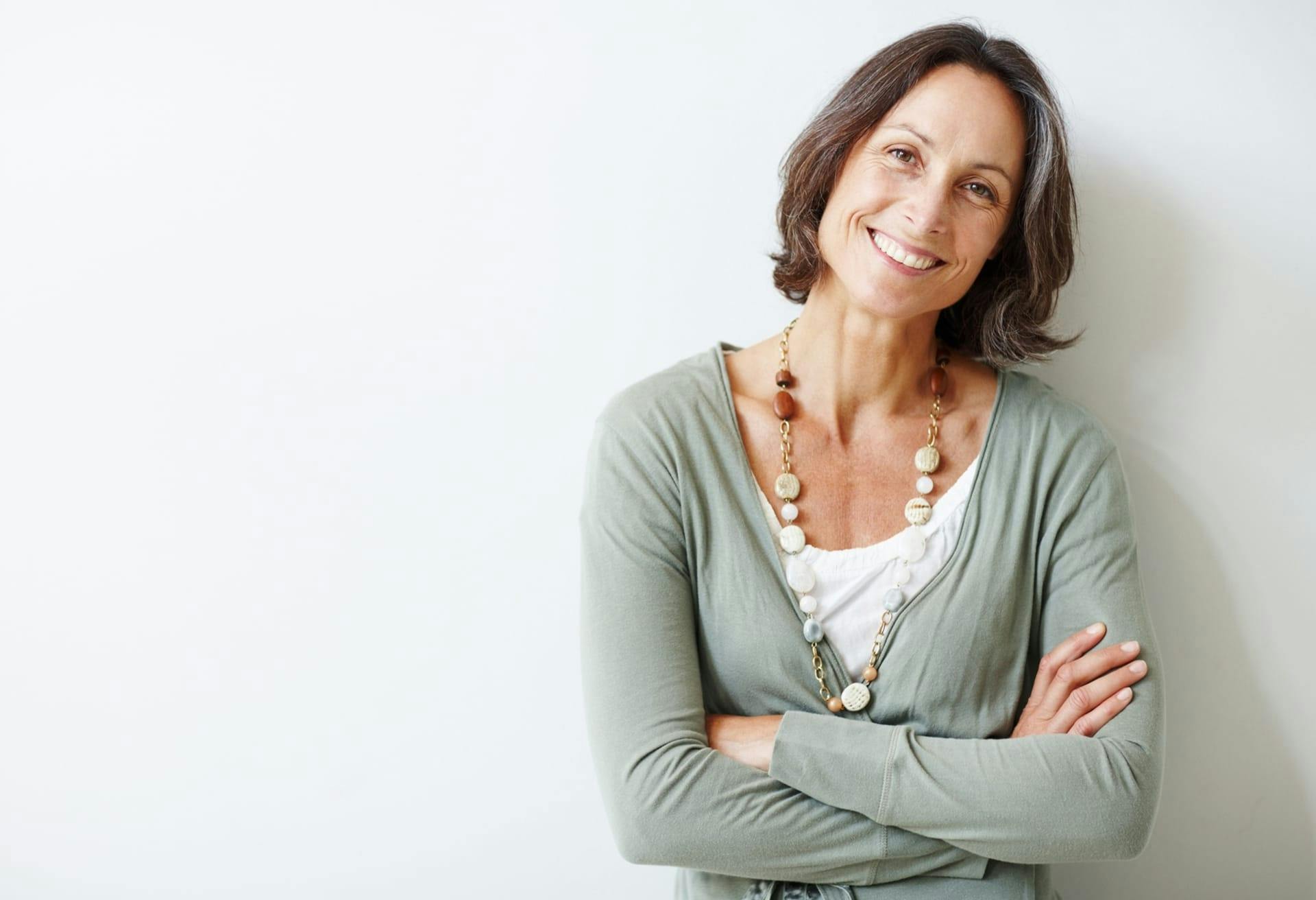 Woman in sage green top smiling