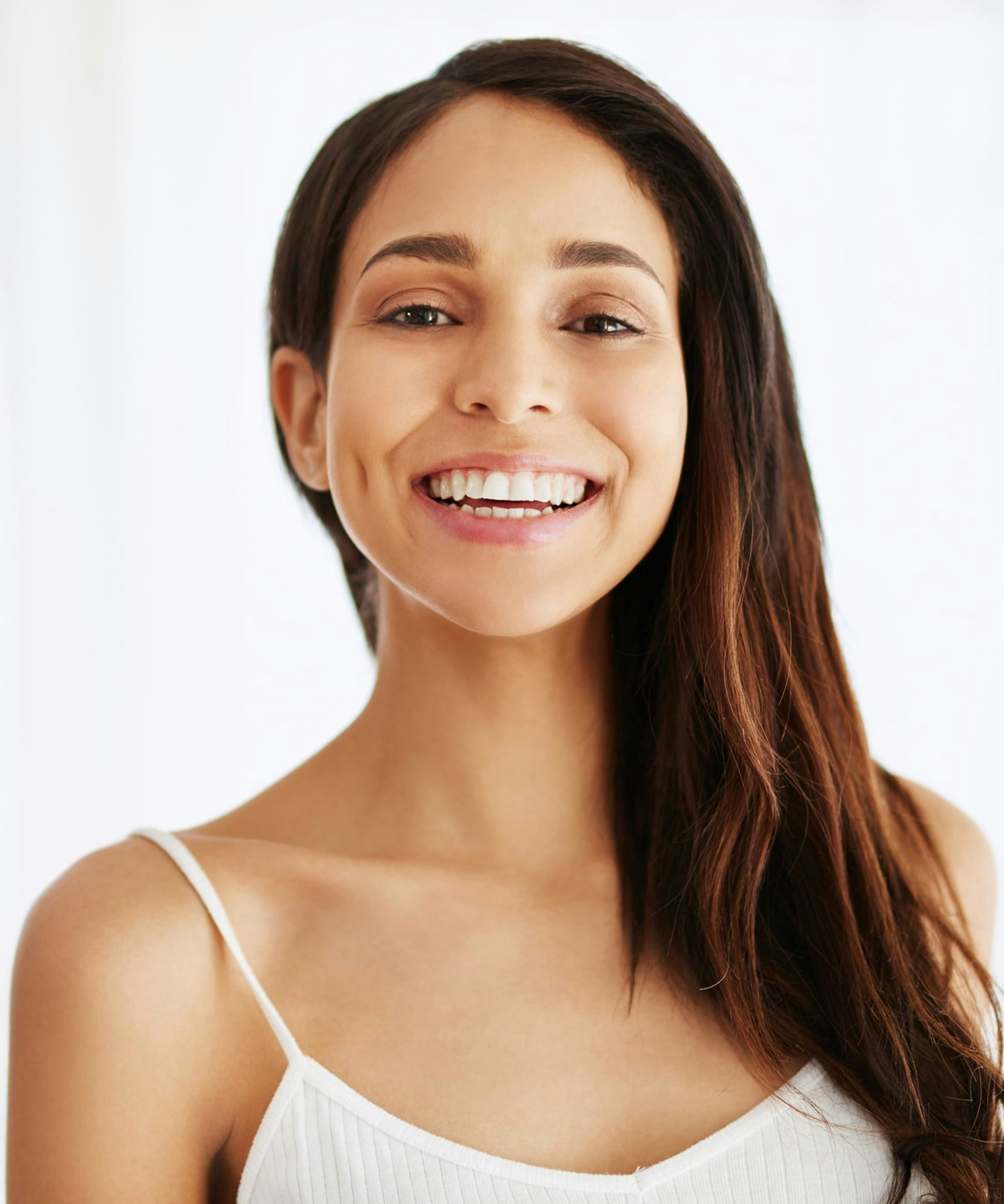 Woman in white tank top smiling