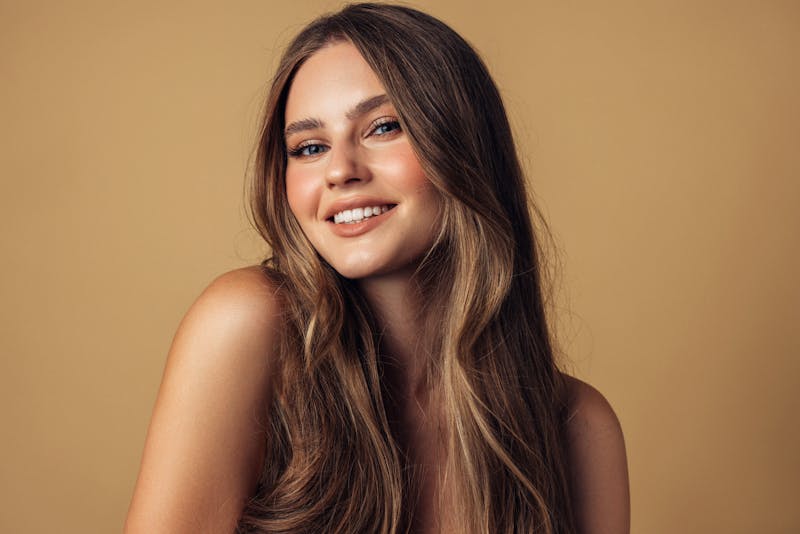 Woman smiling at camera in studio shoot