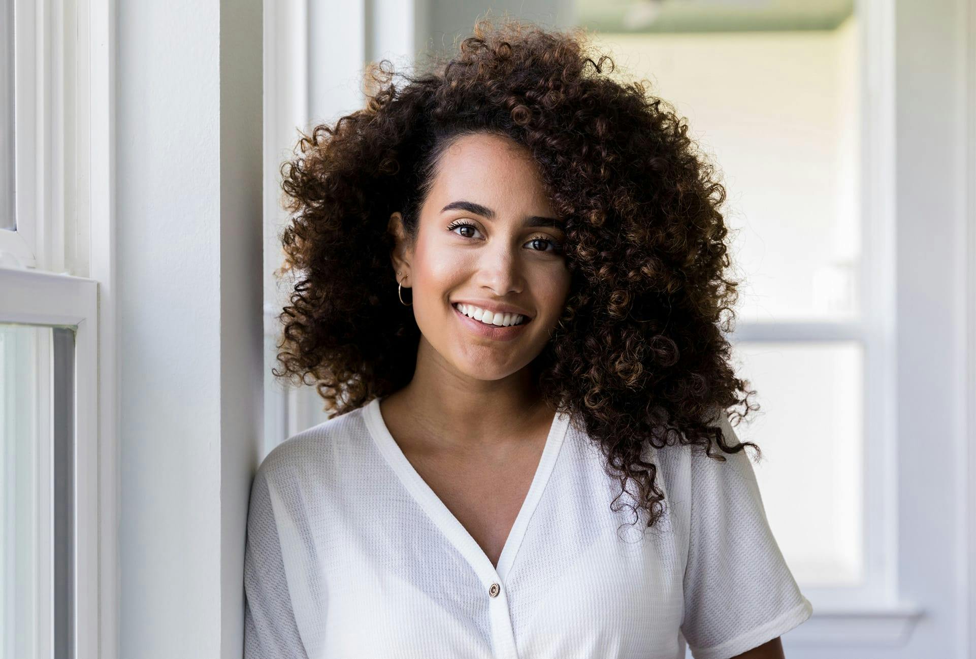 Woman with very curly brown hair