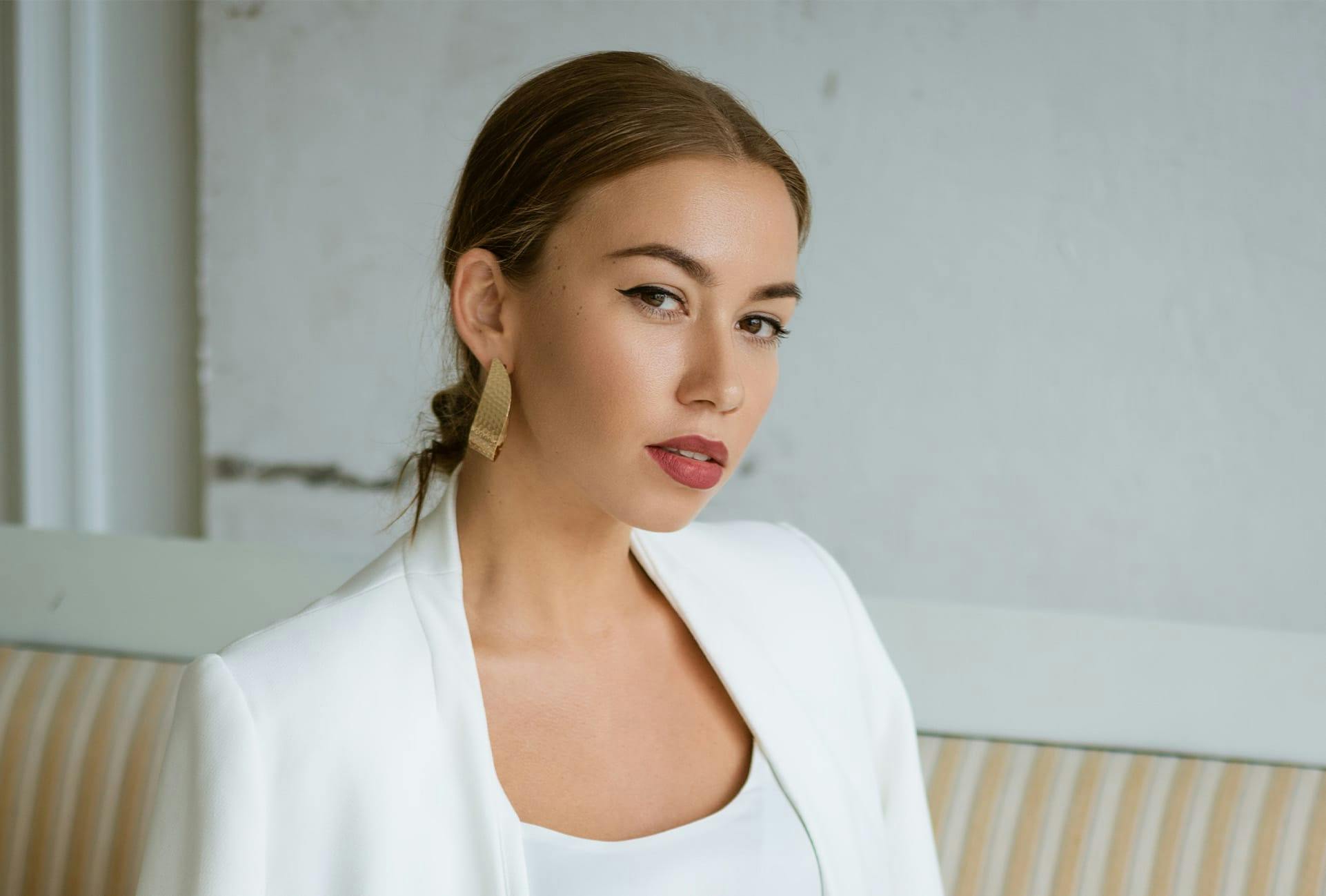 Glamorous woman wearing a white suit jacket