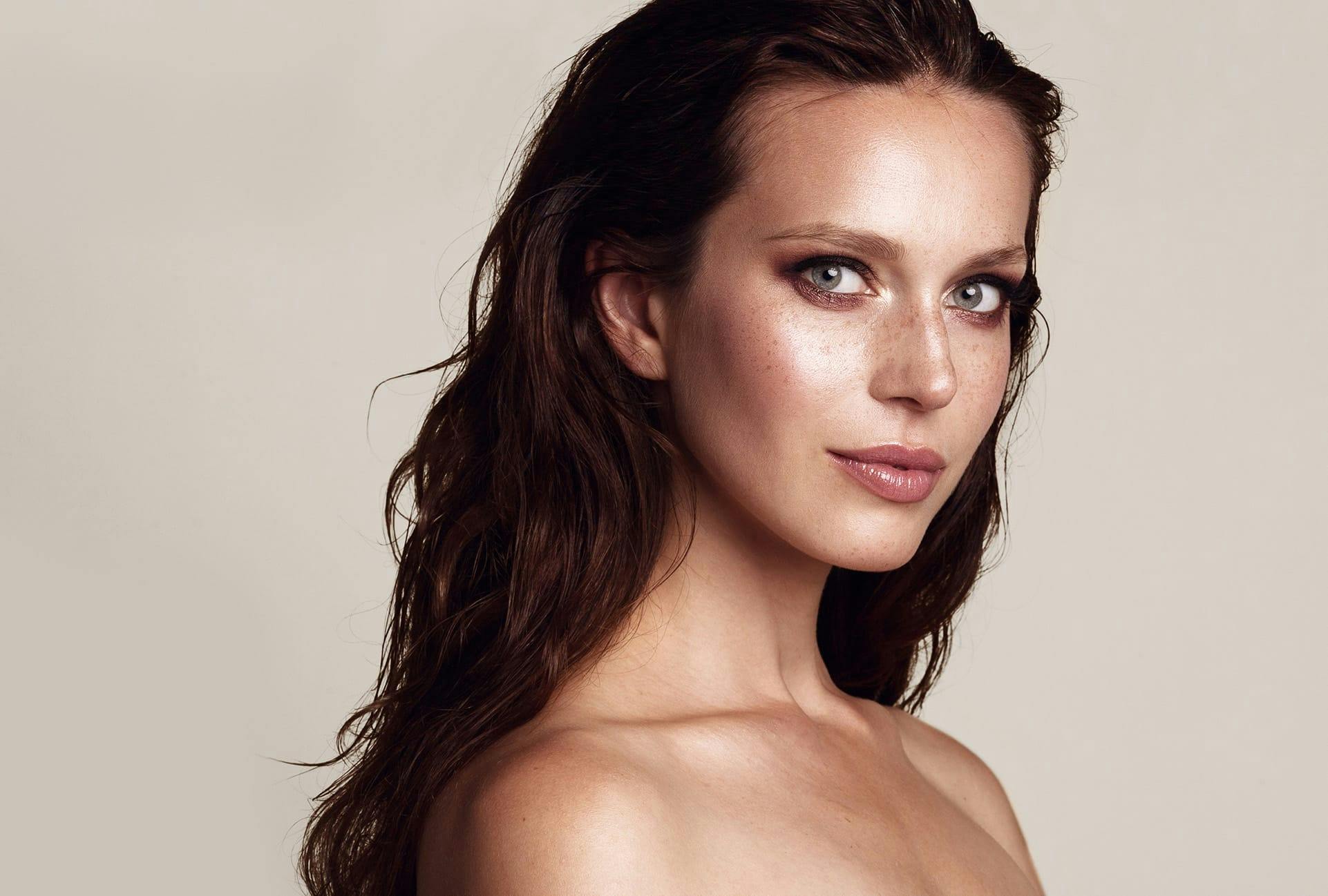 Woman with long dark hair and freckles