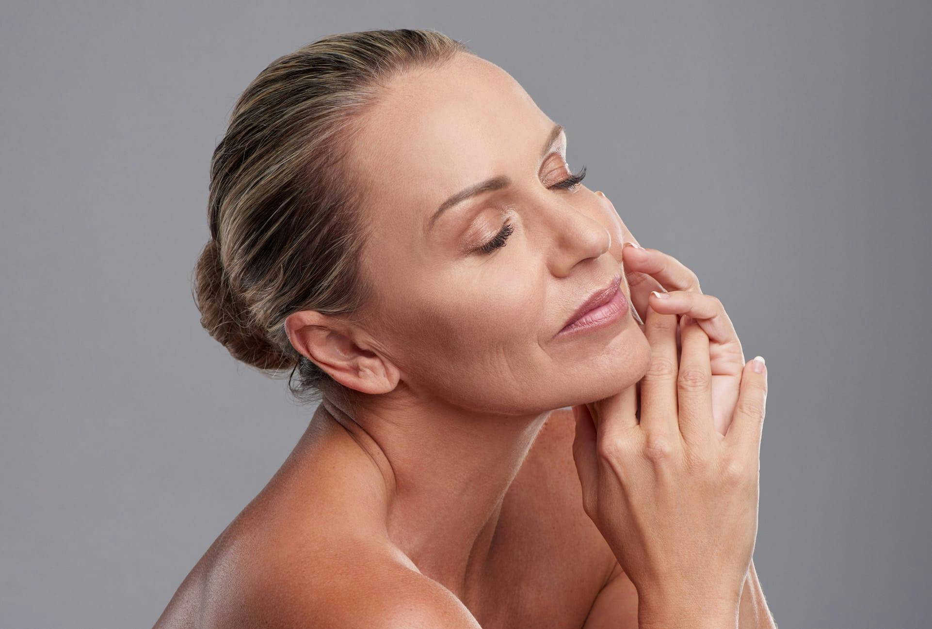 Middle aged woman with her hair pulled back into a low bun