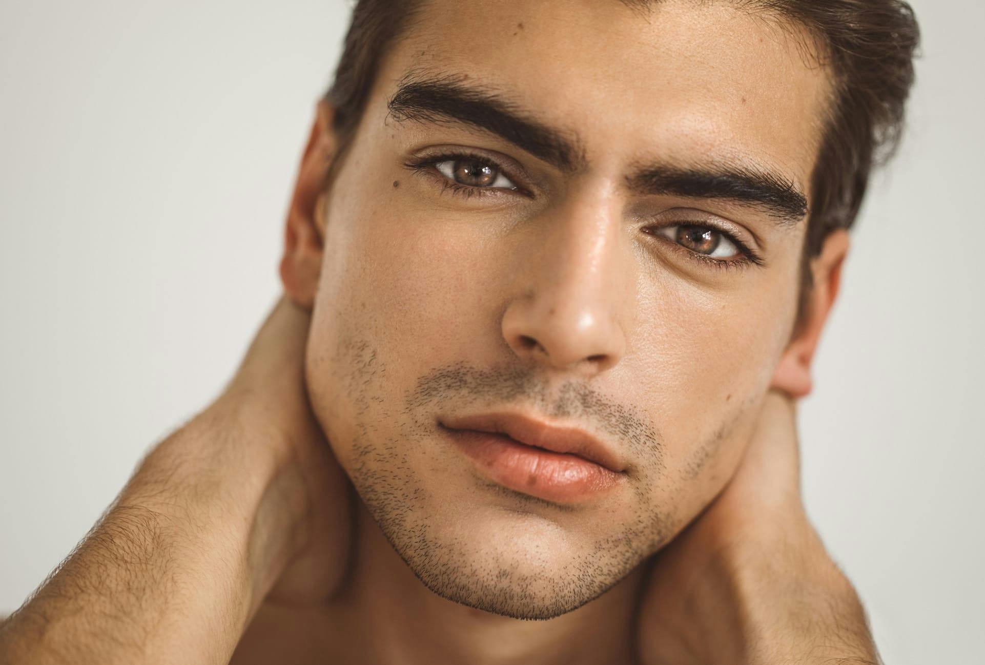 Handsome man with stubble growing back on his lower face