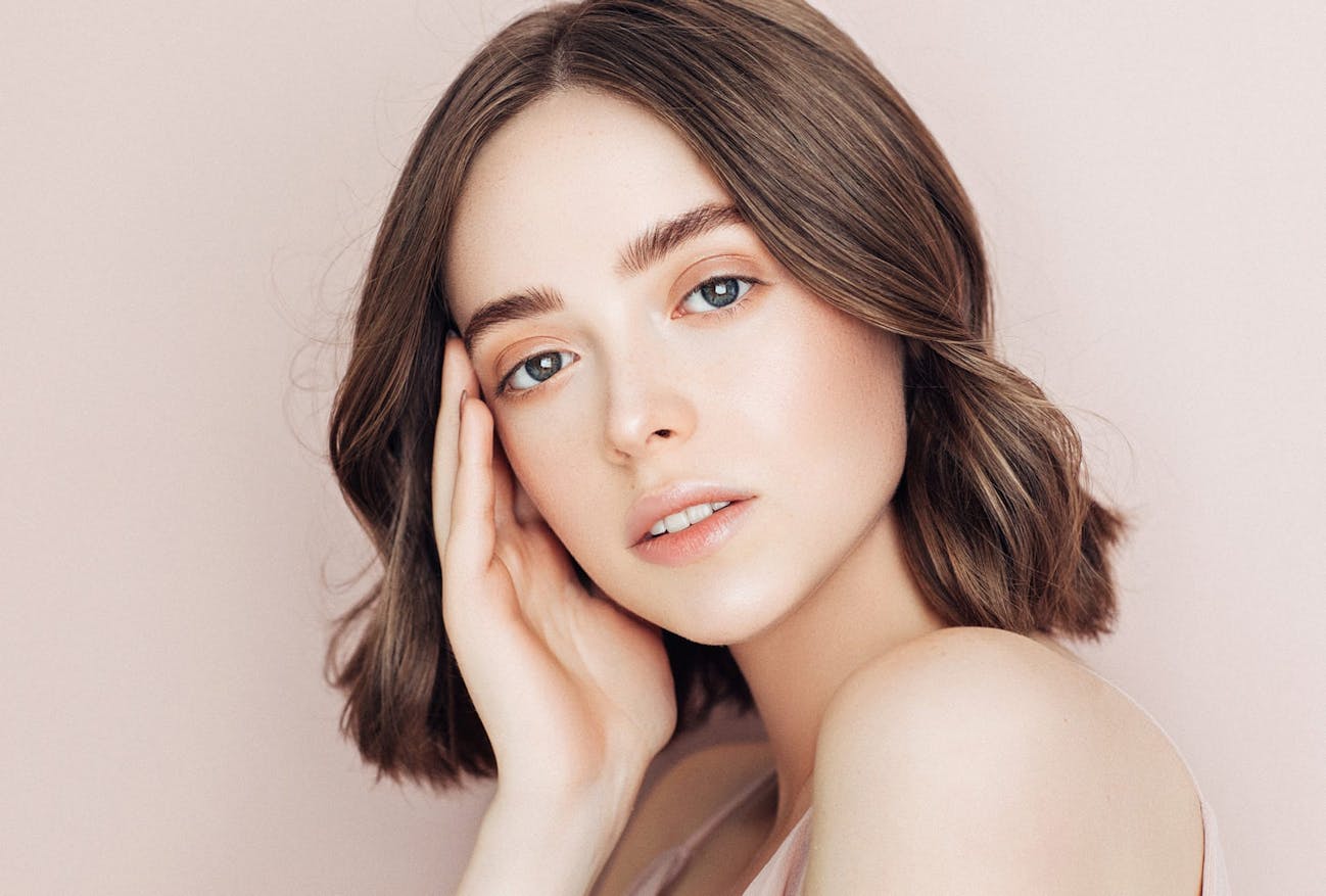 Woman with a hand to her face