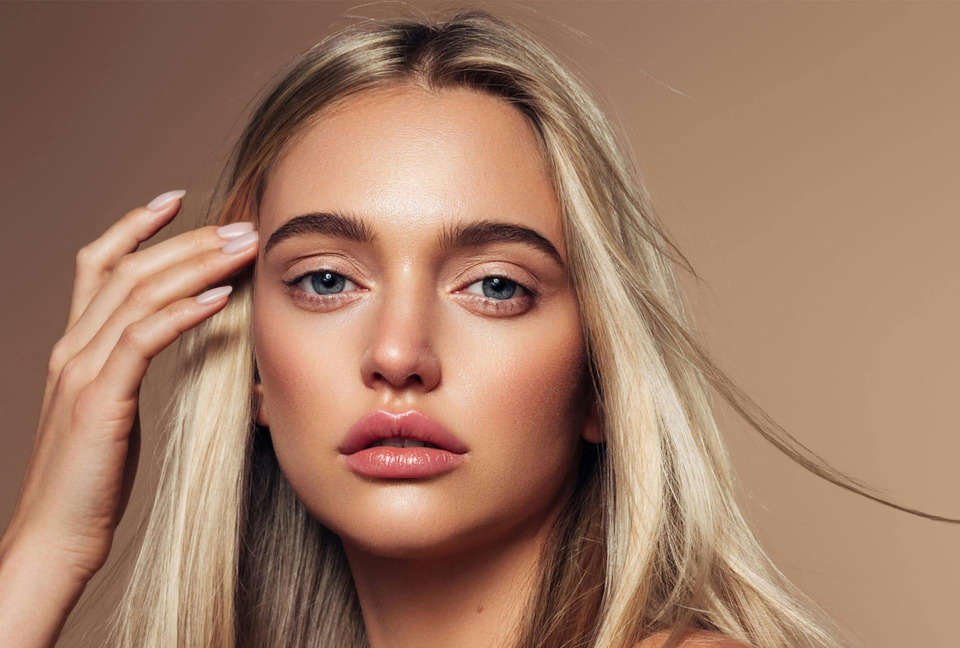 Woman with long blonde hair, blue eyes and full lips