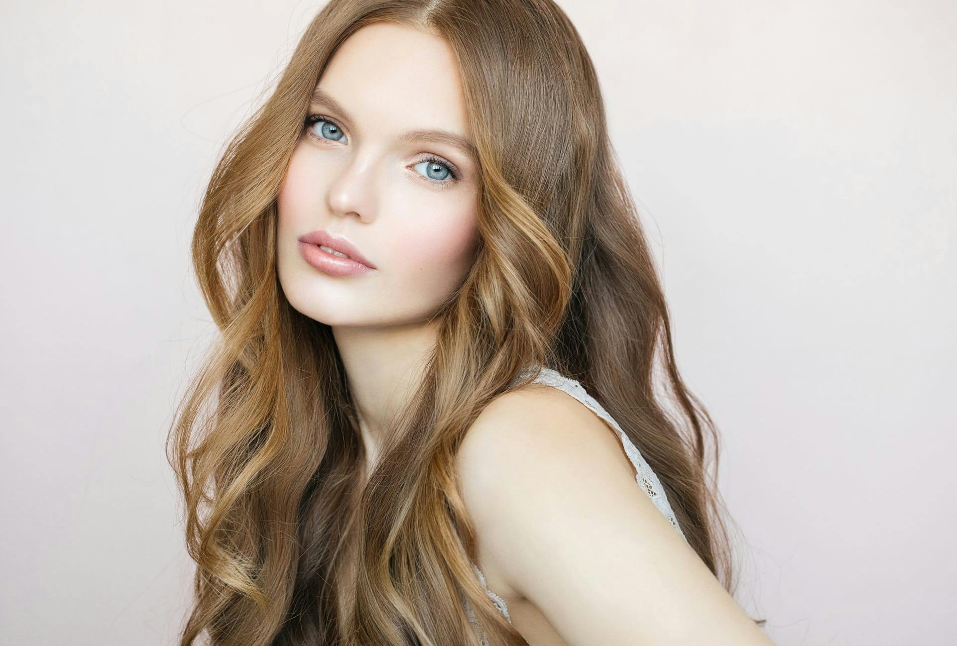Woman with long wavy dark blonde hair